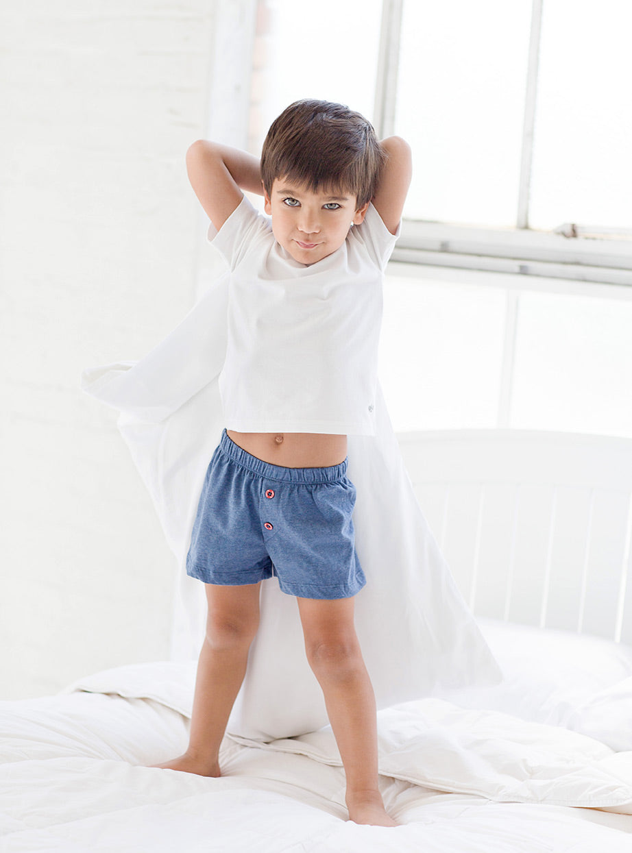 boy in white t-shirt and Noah boxers holding pillow