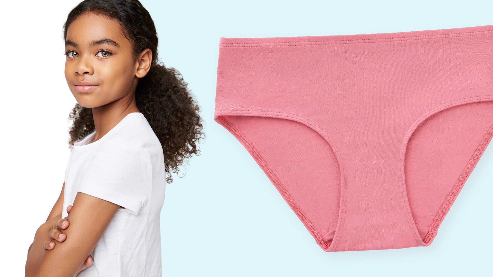 Young tween girl wearing a white t-shirt next to pink underwear on a light blue background