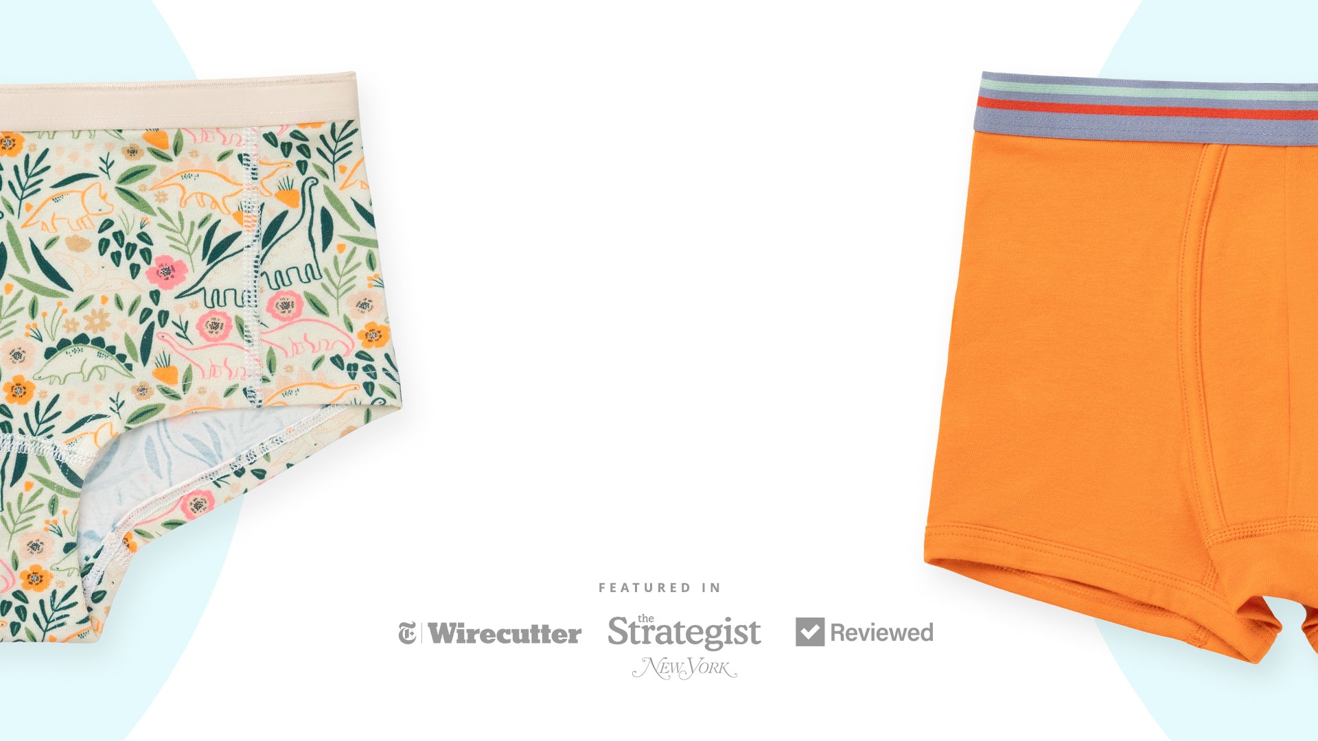 Two pairs of kids underwear, one with floral pattern and the other orange, on a light blue background.
